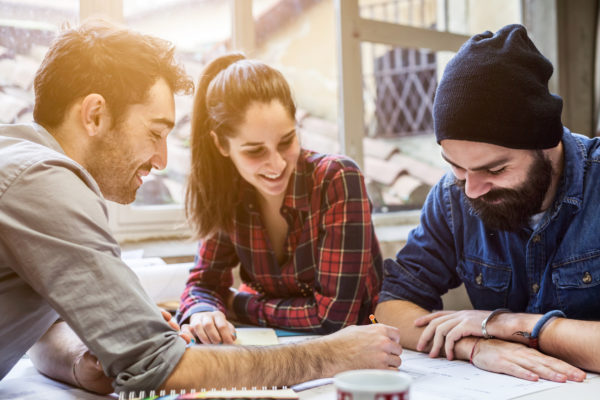 Teamwork. Three young architects working on a project